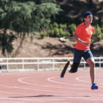 Disabled man athlete training with leg prosthesis. Paralympic Sport Concept.