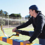 Disabled man athlete stretching with leg prosthesis. Paralympic Sport Concept.