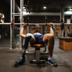Disabled young man training in the gym. Disabled sportsman Concept.