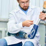 checking limb and adjusting it and checking for quality Custom Orthoses