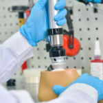 Close up shot of unrecognizable prosthetics technician assembling prosthetic leg in modern laboratory
